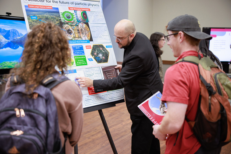 Faculty member talking with student at Faculty Research Showcase