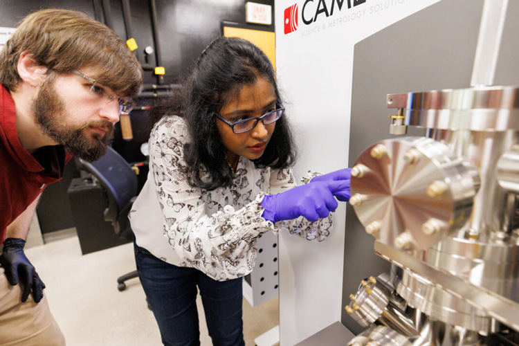 researchers examining atom probe