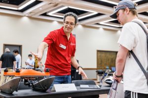 faculty researcher explaining how a drone is used for research purposes