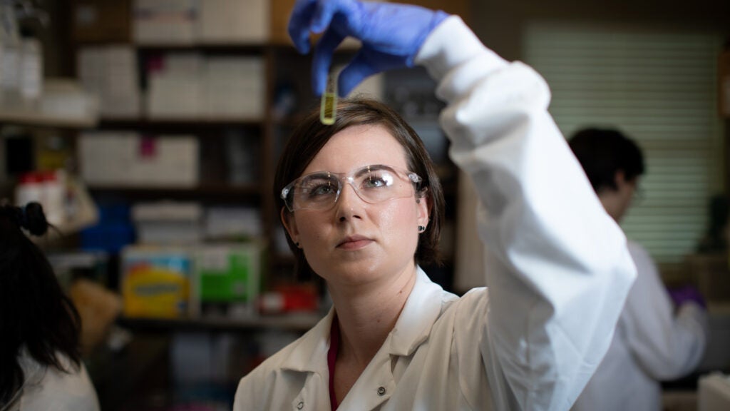 researcher holding up sample