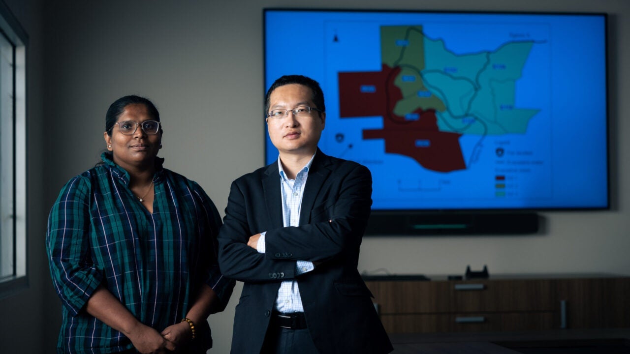 UA researchers in front of wildfire map